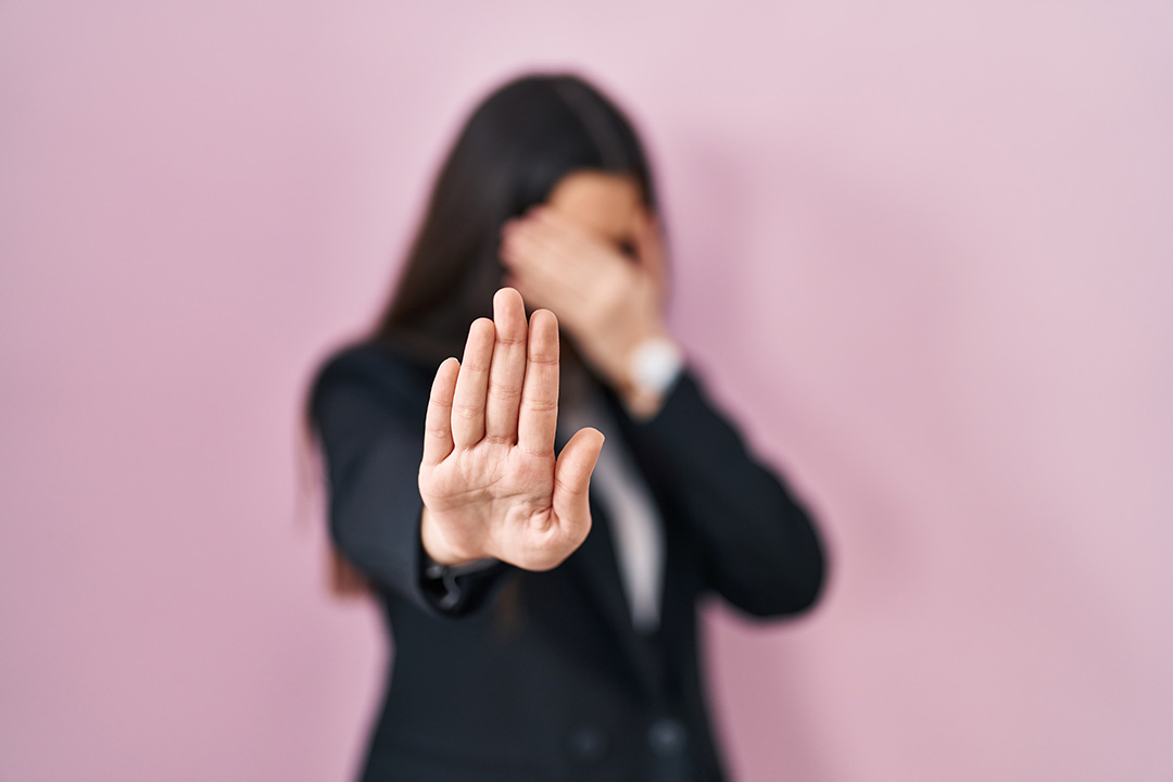 young-brunette-woman-wearing-business-style-pink-background-covering-eyes-with-hands-doing-stop-gesture-with-sad-fear-expression-embarrassed-negative-concept